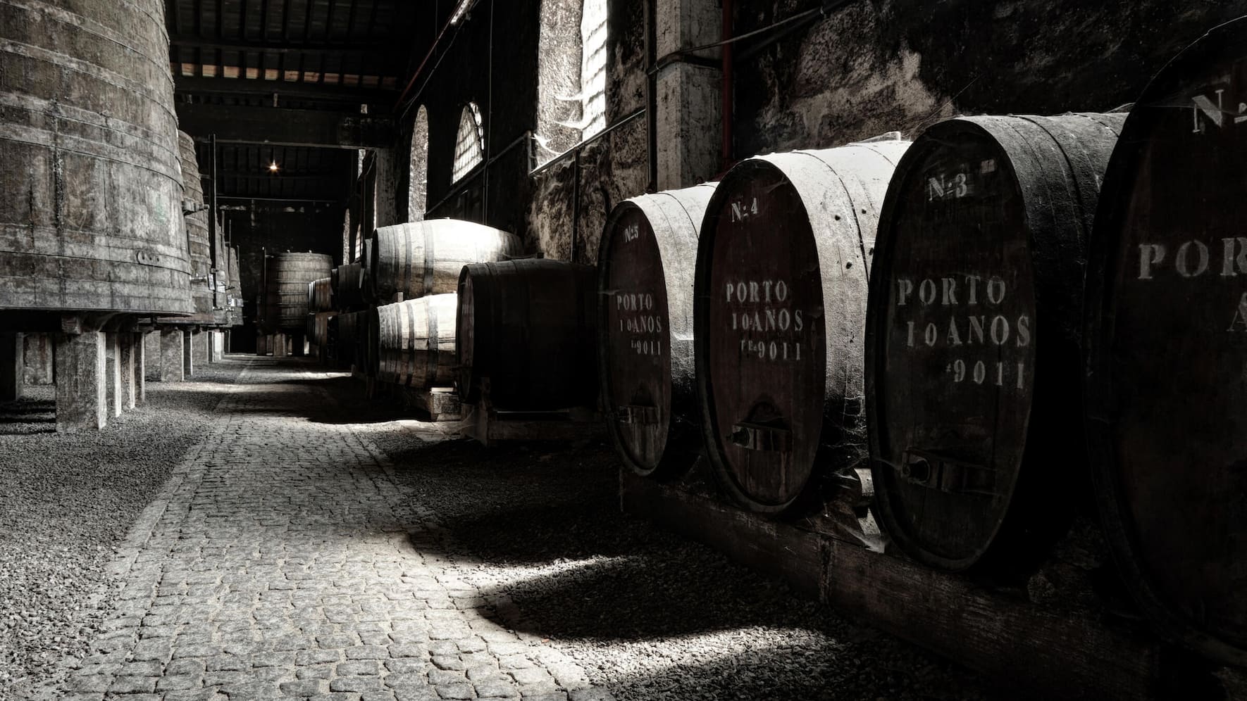 Old Porto wine cellar with wooden barrels in Porto, Portugal