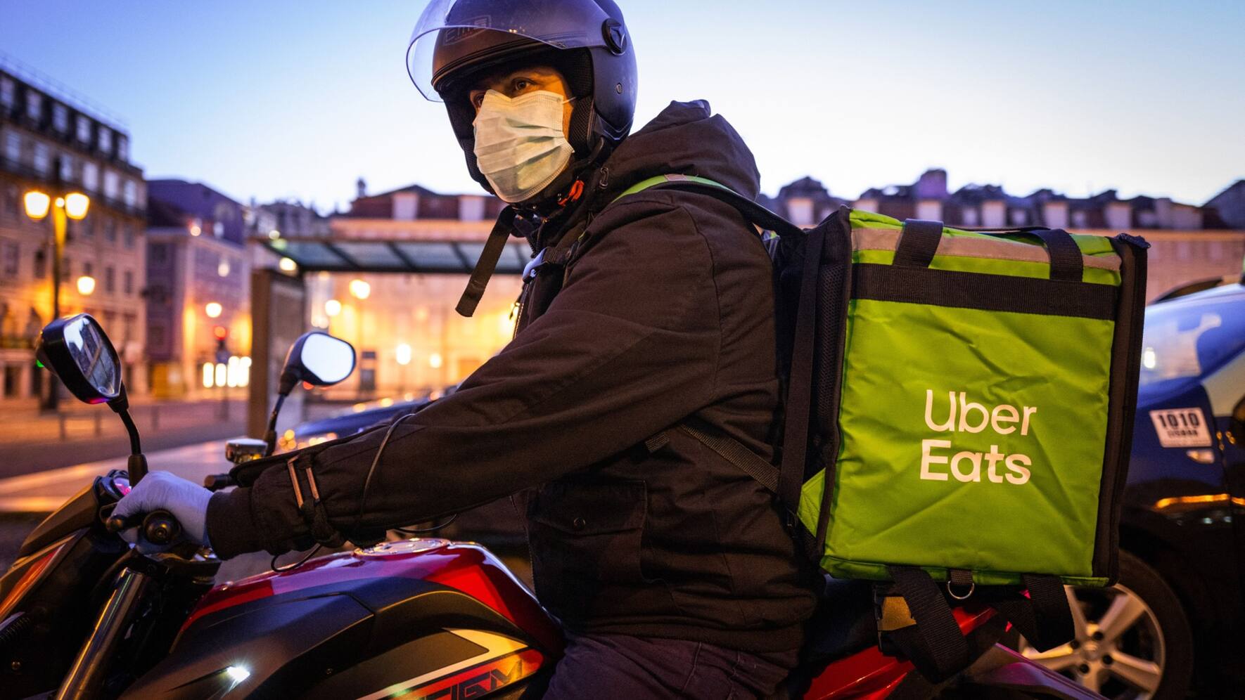 A motorcycle courier for Uber Eats wears a protective face mask whilst making a delivery in Lisbon, Portugal, on Sunday, March 22, 2020. The epidemiological curve of the coronavirus outbreak is estimated to peak around April 14 in Portugal, Health Minister Marta Temido said on Saturday. Photographer: Jose Sarmento Matos/Bloomberg
