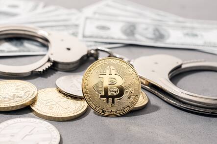 Crypto crime fraud concept. Bitcoin and crypto coins, handcuffs and US dollar banknotes Crypto crime fraud concept. Bitcoin and crypto coins, handcuffs and US dollar banknotes Copyright: xZoonar.com/AndresxVictorerox 19416778