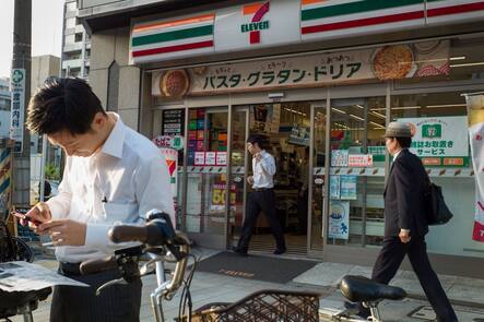 A customer leaves a 7-Eleven convenience store, operated by Seven & i Holdings Co., in Tokyo, Japan, on Friday, Oct. 6, 2017. Seven & i is scheduled to report its second-quarter earnings results on Oct. 12. Photographer: Kentaro Takahashi/Bloomberg