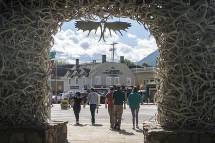 Tourists walk around Town Square in Jackson, Wyo. on Aug. 23, 2023. When Federal Reserve Chair Jerome Powell delivers a high-profile speech Friday in Jackson Hole, many analysts think he could make one thing clear: That the Fed plans to keep its benchmark interest rate at a peak level for longer than had been expected. (AP Photo/Amber Baesler)