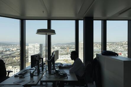 A GAM employee works at his desk in an office at the Prime Tower, a skyscraper, where the pure play asset management group GAM is headquartered, pictured in Zurich, Switzerland, on March 13, 2017. (KEYSTONE/Gaetan Bally)