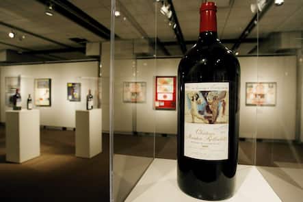 epa00940257 A bottle of Chateau Mouton Rothschild wine featuring a painting by Pablo Picasso is displayed at an exhibit of the wines and their artist-rendered labels at Sotheby's in New York, New York on Friday 23 February 2007. Sotheby's holding the exhibit before a 28 February 2007 auction of special wines from the Baroness Philippine de Rothschild's private cellar which is expected to bring in $570,000 - $885,000. EPA/JUSTIN LANE