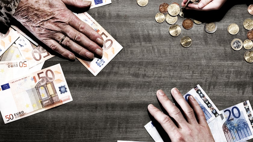 3 generations of hands with euro coins and notes on table