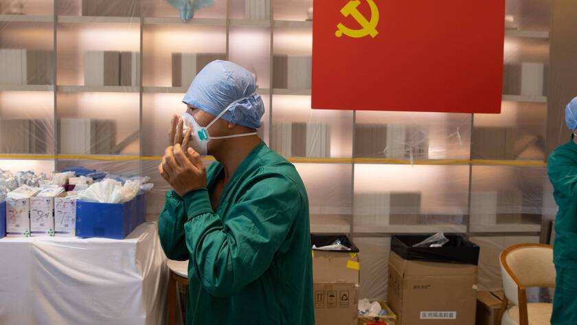 220510 -- SHANGHAI, May 10, 2022 -- Meng Xiangjun and Zhang Zhimin L wear protective suits at the headquarters of a medical emergency team on Caoyang Road in east China s Shanghai, May 9, 2022. A medical emergency team consisting of 108 members with 50 ambulances from north China s Tianjin has arrived at Shanghai to assist in the city s public medical emergency service amid the COVID-19 resurgence. CHINA-SHANGHAI-MEDICAL TEAM-COVID-19-AID CN JinxLiwang PUBLICATIONxNOTxINxCHN