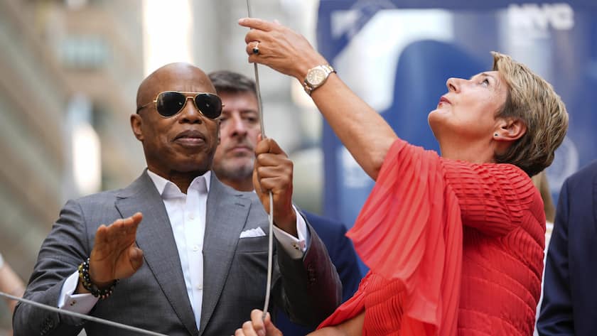 New York Mayor Eric Adams, left, and Swiss Federal Councillor Karin Keller-Sutter, right, raise an American flag during a Swiss National Day flag raising ceremony at Bowling Green, Thursday, Aug. 1, 2024, in New York. (AP Photo/Julia Nikhinson)