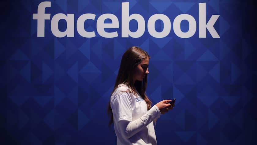 October 14, 2021, LONDON, UK: File photo dated 03/11/15 of a woman using her phone under a logo of Facebook. A global group of more than 50 child safety organisations and campaigners has urged Mark Zuckerberg to make Facebook safer for children, sending an open letter to the social network founder calling for more transparency on how the platform plans to tackle the issue. LONDON UK PUBLICATIONxINxGERxSUIxAUTxONLY - ZUMAp134 20211014_zba_p134_258 Copyright: xNiallxCarsonx