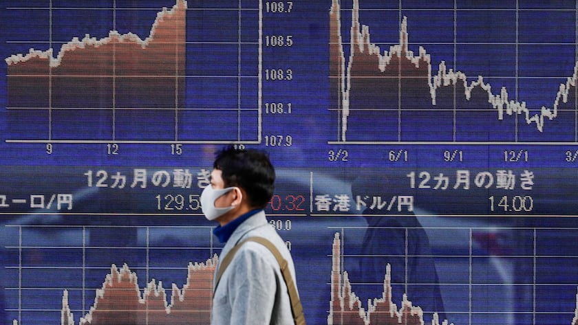 March 11, 2021, Tokyo, Japan: A man wearing a face mask as a preventive measure against the spread of Covid-19 walks past an electronic board showing currency exchange rates at a securities firm in Tokyo. Tokyo Japan - ZUMAs197 20210311_zab_s197_042 Copyright: xJamesxMatsumotox