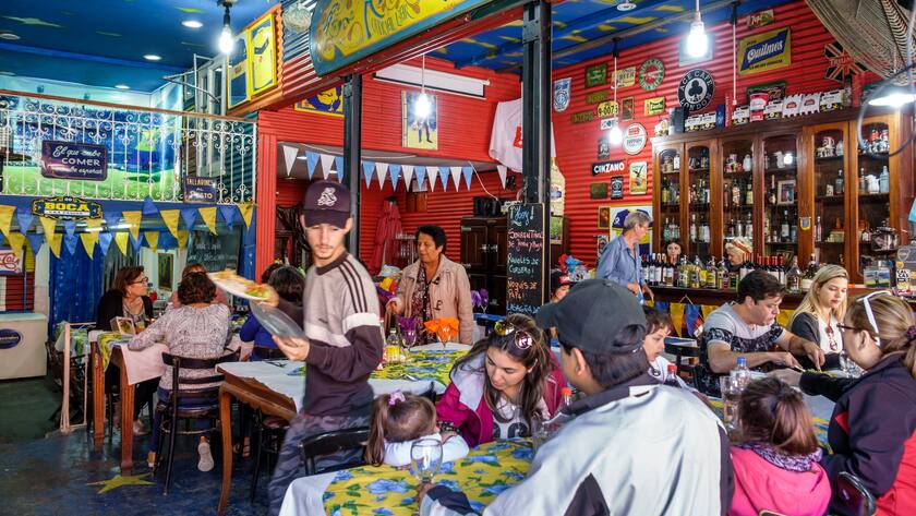 Argentina, Buenos Aires, Caminito Barrio de la Boca, street museum, immigrant neighborhood, La Cancha, restaurant, casual dining, Hispanic, man, woman, girl, family, waiter, interior, Argentinean Argentinian Argentine South America American,