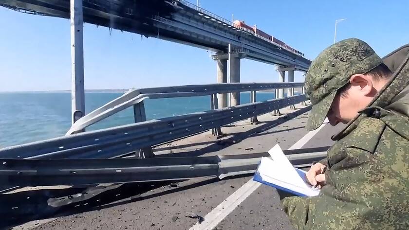 Russian Investigative Committee employees work at the site of a bridge linking Crimea to mainland Russia after a truck exploded, on Saturday, October 8, 2022. Moscow announced that a truck exploded igniting a huge fire and damaging the key Kerch bridge built as Russia s sole land link with annexed Crimea. A still image grabed from a video provided by Russian Investigative Committee/ 1 RUS2022100814 RussianxInvestigativexCommittee