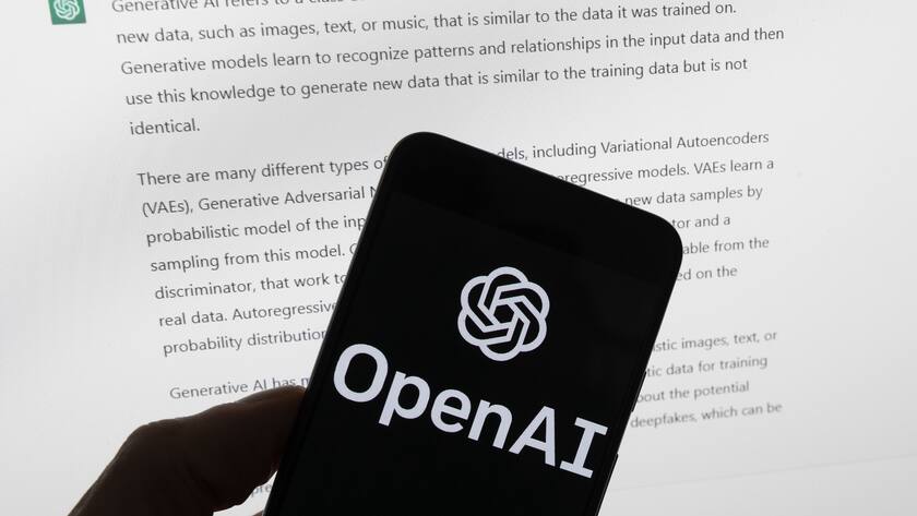 FILE - The OpenAI logo is seen on a mobile phone in front of a computer screen displaying output from ChatGPT, March 21, 2023, in Boston. OpenAI plans to halt the use of one of its ChatGPT voices after some drew similarities to actor Scarlett Johansson, who famously portrayed a fictional AI assistant in the (perhaps no longer so futuristic) film ?Her.? (AP Photo/Michael Dwyer, File)