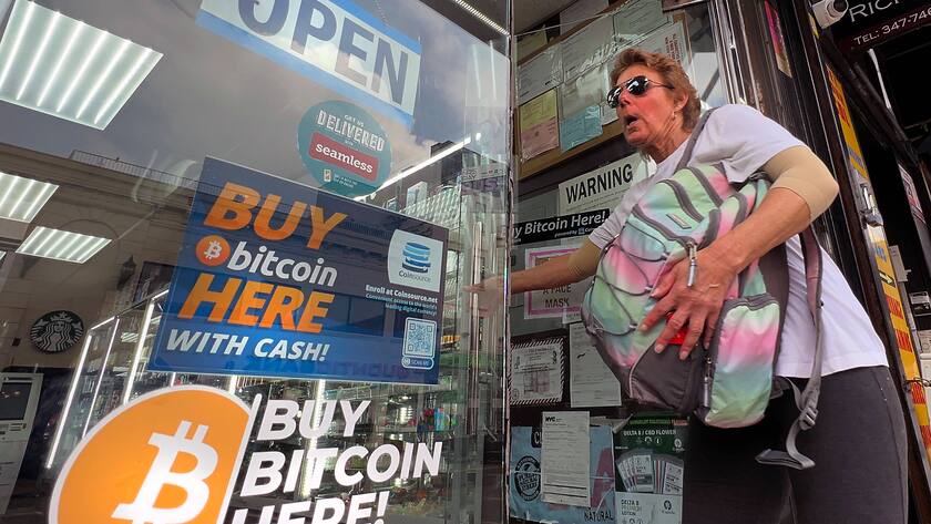 June 3, 2022, NEW YORK CITY, NEW YORK, USA: A woman leaves a convenience store that has a bitcoin ATM inside In New York City, June 3, 2022. Lawmakers in New York passed a bill to ban certain bitcoin mining operations that run on carbon-based power sources. NEW YORK CITY USA - ZUMAs139 20220603_zap_s139_004 Copyright: xStephenxShaverx