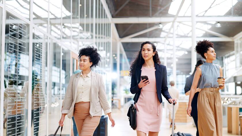 Drei Frauen am Flughafen auf einer Geschäftsreise.