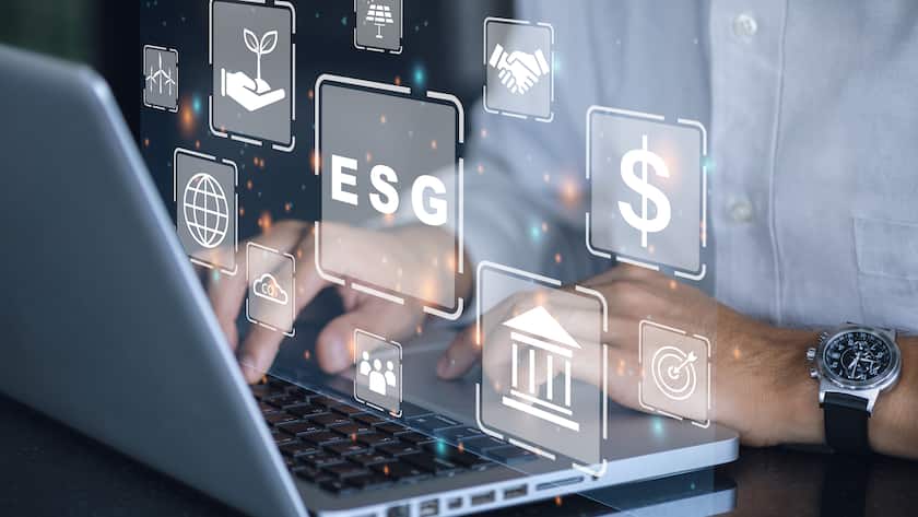 Businessman using a computer for analysis ESG environmental social governance business strategy investing concept.
