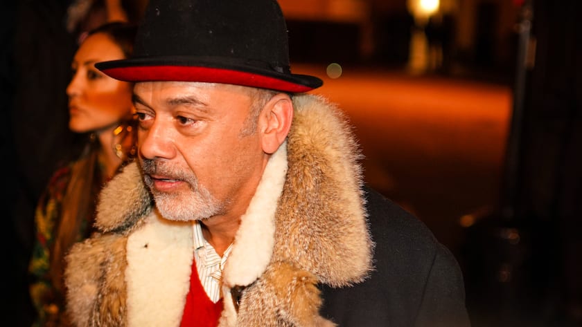 PARIS, FRANCE - JANUARY 23: Christian Louboutin wears a black and red hat, a black winter coat, a red top, outside Valentino, during Paris Fashion Week - Haute Couture Spring Summer 2020, on January 23, 2019 in Paris, France. (Photo by Edward Berthelot/Getty Images)
