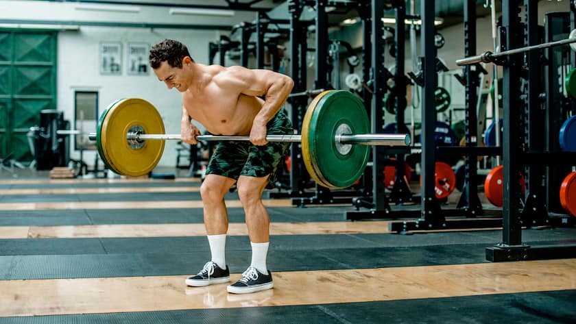 Muscular man lifting weights in health club model released Symbolfoto property released KVF00178