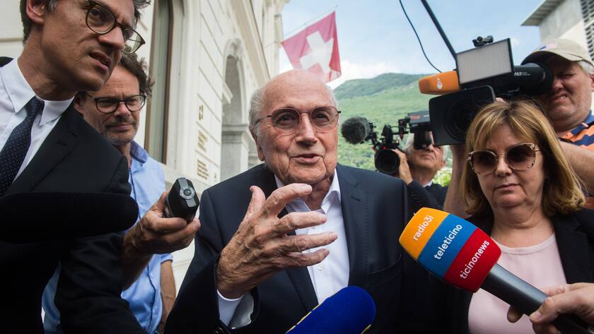 Former FIFA president Sepp Blatter is surrounded by the media as he leaves the Swiss Federal Criminal Court in Bellinzona, Switzerland, Wednesday, June 8, 2022. Blatter and former UEFA president Michel Platini have arrived at a Swiss criminal court for their 11-day trial on charges of defrauding FIFA, the world governing body of soccer. (Alessandro Crinari/Keystone via AP)