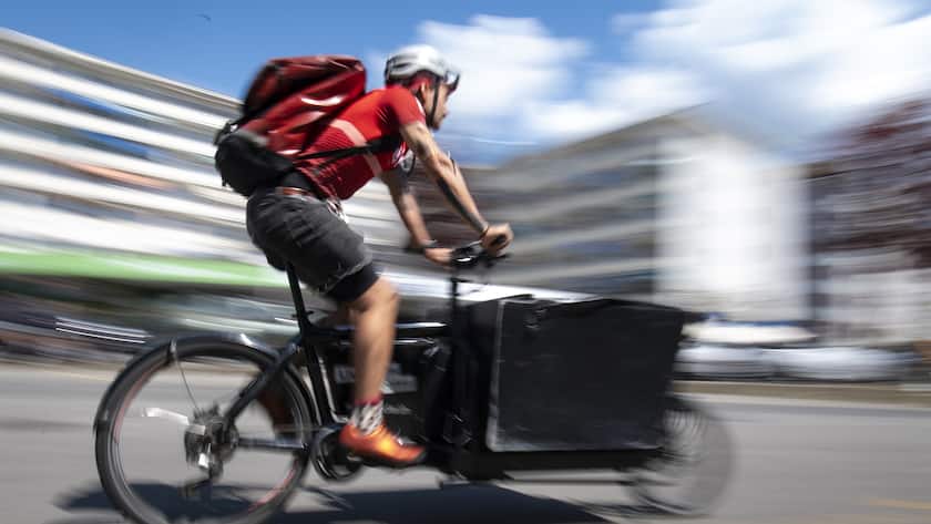 Jean-Sebastien Luy, co-director and courier of velocite delivery company rides a cargo bicycle to bring food to people in lockdown during the state of emergency of the coronavirus disease (COVID-19) outbreak, in Lausanne, Switzerland, Friday, April 24, 2020. Countries around the world are taking increased measures to stem the widespread of the SARS-CoV-2 coronavirus which causes the Covid-19 disease. (KEYSTONE/Laurent Gillieron)