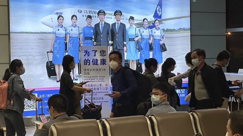 Passengers prepare to board a flight at the airport in north-central China's Jiangxi province on Nov. 1, 2022. The Chinese government said Tuesday, Dec. 27 it will start issuing new passports as it dismantles anti-virus travel barriers, setting up a potential flood of millions of tourists out of China for next month's Lunar New Year holiday. (AP Photo/Ng Han Guan)