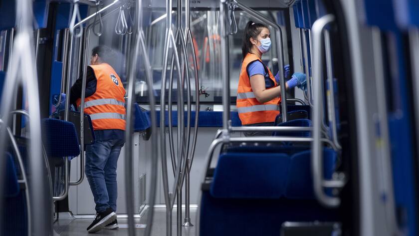 ISS facility services worker wearing protective face mask disinfects the interior of a underground carriage of the "Transports publics lausannois"