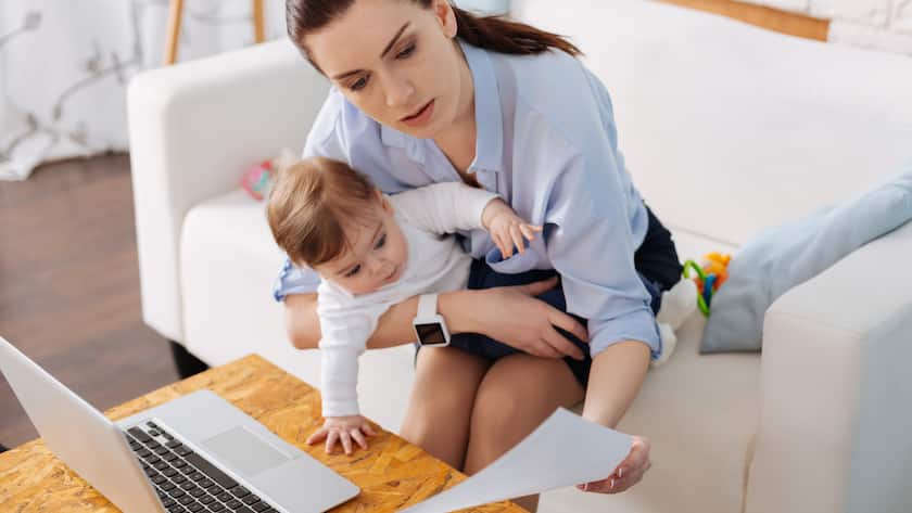Curiosity in action. Sweet charming clever child taking a look at a piece of paper her mother holding while being amused by it