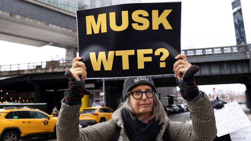 February 9, 2025, New York, New York, USA: A demonstrator wears a hat that reads RESIST and holds a sign that reads MUSK WTF outside the Tesla Showroom in ManhattanÃââ s West Village. The activist group Rise & Resist holds a Stop the Musk-Trump Coup protest on Super Bowl Sunday in response to President Trump and E. MuskÃââ s actions at the United States DOGE Service New York USA - ZUMAr174 20250209_znp_r174_038 Copyright: xGinaxMxRandazzox