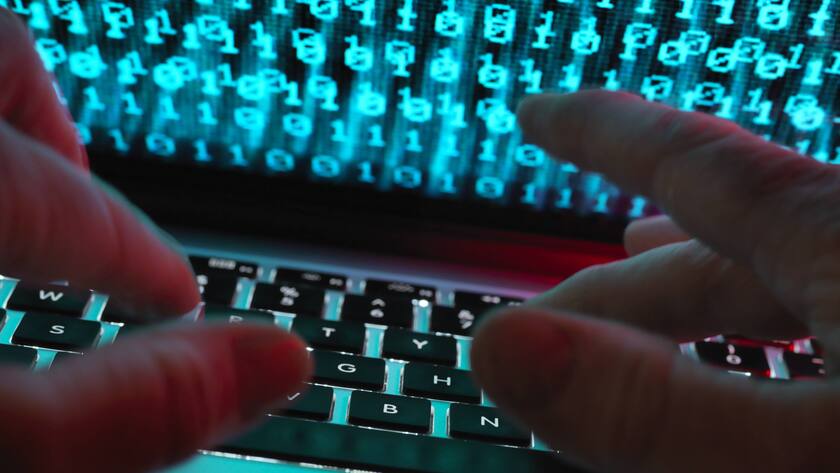 Hacker coding a computer virus infecting a laptop model released Symbolfoto property released PUBLICATIONxINxGERxSUIxAUTxHUNxONLY ABRF00346