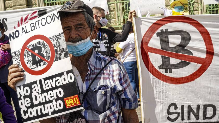 December 12, 2021, San Salvador, El Salvador: Protestors hold placards against the Bitcoin law during the protest..Demonstrators took to the streets to protest the government of Nayib Bukele and his policies. Recently the United States Biden administration accused the Salvadoran government officials of corruption and a secret truce with organized crime such as MS-13 and Barrio 18 to lower homicide records. San Salvador El Salvador - ZUMAs197 20211212_zaa_s197_146 Copyright: xCamiloxFreedmanx