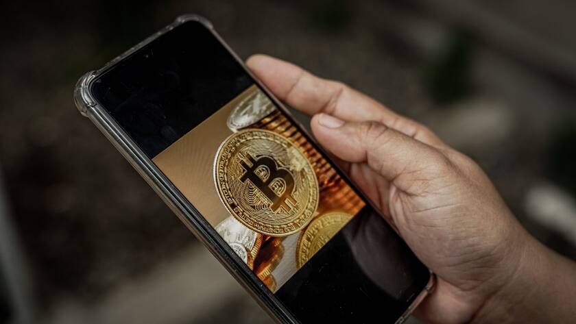 May 13, 2022, Makassar, South Sulawesi, Indonesia: A woman is holding a cell phone showing a bitcoin image on the screen. The last few days, the price of bitcoin has decreased drastically. Makassar Indonesia - ZUMAb223 20220513_zip_b223_002 Copyright: xHerwinxBaharx