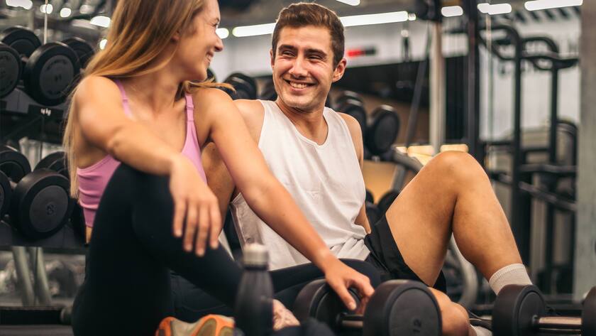 Man and woman exercise workout in gym fitness breaking relax with dumbbell on the floor, Model released, Property released PedroMerino_GymCrossfitFriends_56.jpg Copyright: xPedroxMerinox