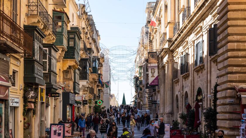 Valletta, Malta - 01 07 2022: People walkjing i the main street with shops and restaurants