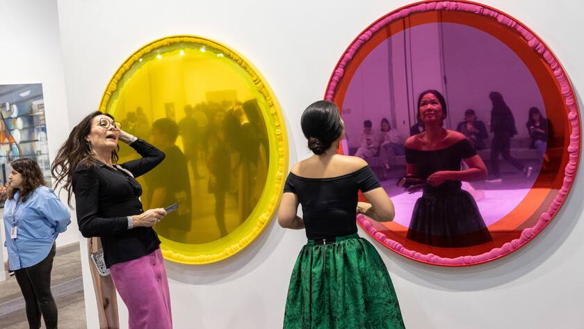 epa10534562 Visitors look at their reflections in mirrors during a private view at Art Basel in Hong Kong, China, 21 March 2023. The two-day art fair opens to the public on 23 March. EPA/JEROME FAVRE
