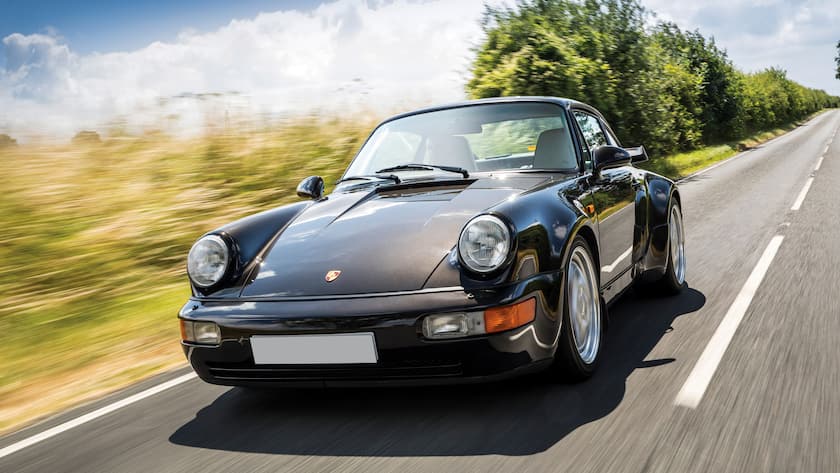 A 1991 Porsche 911 Turbo 3.6 sports car driving on a rural road, taken on July 11, 2018. (Photo by Daniel Pullen/Future Publishing via Getty Images)