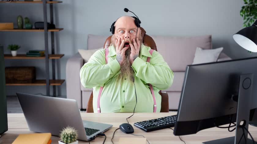 Portrait of attractive angry mad guy answering client calls hot line help desk at office indoor work place station.