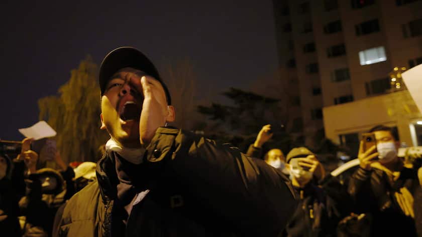 epa10332582 Protesters shout while holding blank white pieces of paper during a protest triggered by a fire in Urumqi that killed 10 people in Beijing in Beijing, China, 27 November 2022. Protests against's China strict Covid restrictions have erupted in various cities including Beijing and Shanghai, triggered by a tower fire that killed 10 people Xinjiang's capital, Urumqi. The blank pieces of paper are a symbol of protest against censorship and free speech. EPA/MARK R. CRISTINO