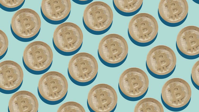 Cross Section of Gold Bitcoin in a row on blue background