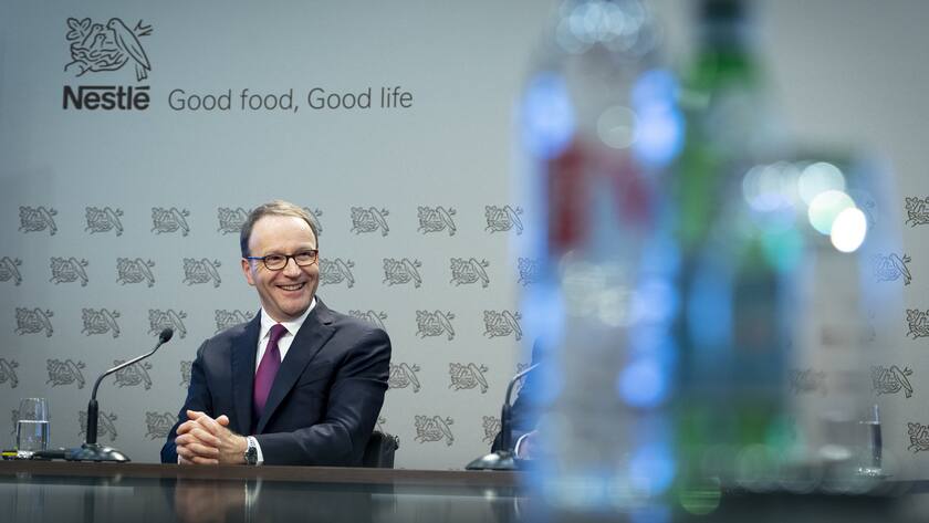 Nestle's CEO Ulf Mark Schneider smiles next to bottles of water during the 2019 full-year results press conference of the food and drinks giant Nestle, in Vevey, Switzerland, Thursday, February 13, 2020. (KEYSTONE/Laurent Gillieron)