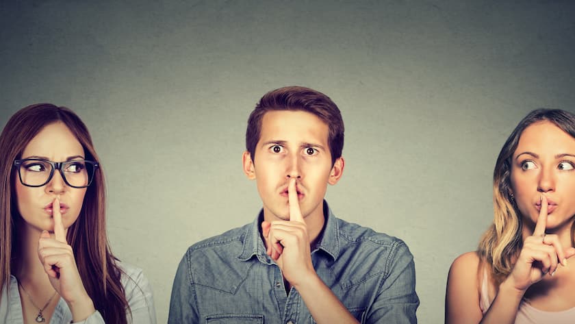Secretive people man and two women with finger to lips gesture