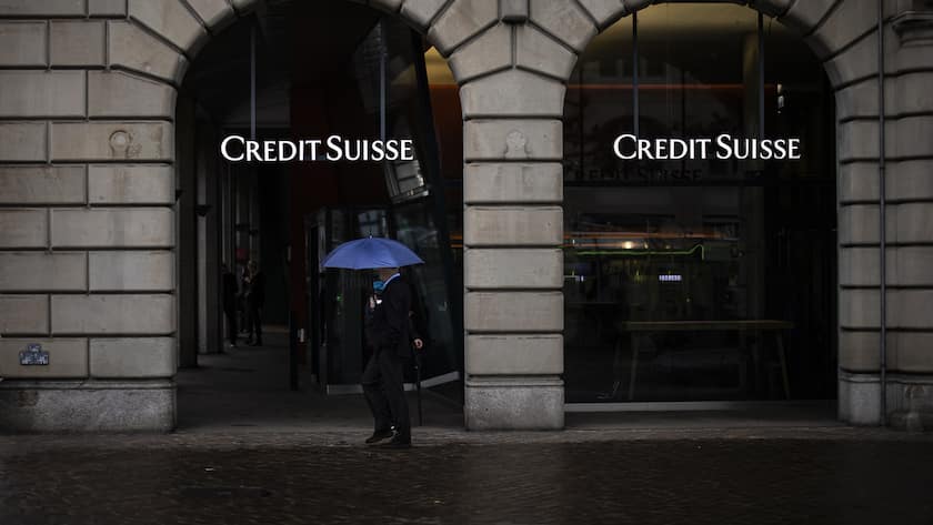A person walks past a logo of the Swiss bank Credit Suisse in Zurich, Switzerland, on Friday, March 24, 2023. (KEYSTONE/Michael Buholzer).