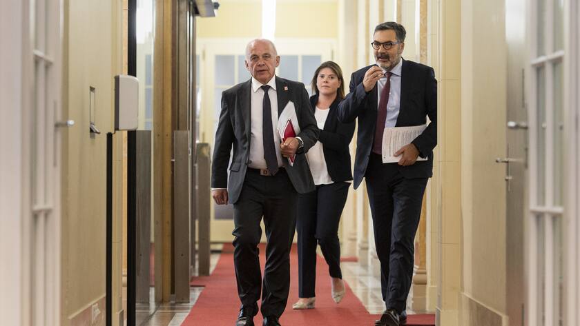 Bundesrat Ueli Maurer, links, schreitet am Freitag, 15. Oktober 2021 in Bern mit Tamara Pfammatter, Leiterin Steuern im Staatssekretariat fuer internationale Finanzfragen, Mitte, und Peter Minder, Leiter Kommunikation im EFD, zu einer Medienkonferenz, um vom G20-Finanzministertreffen und der Jahrestagung von IWF und Weltbank diese Woche in Washington zu berichten. (KEYSTONE/Alessandro della Valle)