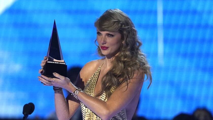 Taylor Swift hält den American Music Award in der Hand.