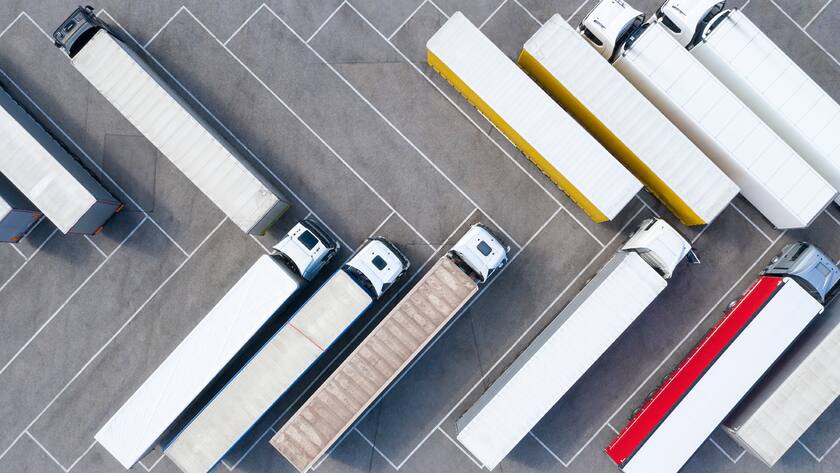 Heavy goods transportation - trucks in truck stop from above.