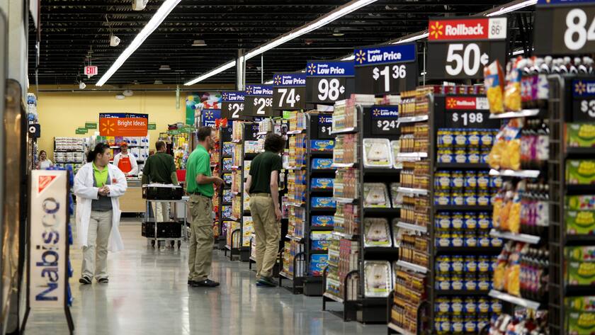 Employees and shoppers move through the aisles at Wal-Mart Neighborhood Market in Bentonville, Ark., Thursday June 5, 2014. (AP Photo/Sarah Bentham)