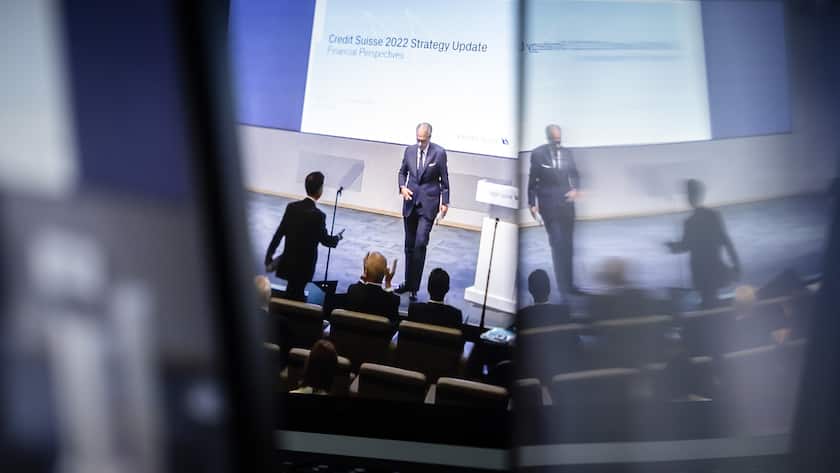 Swiss bank Credit Suisse CEO Ulrich Koerner, center, is seen on screens presenting the quarterly report and the strategy and transformation plan for the bank taken from a webcast streaming in Zurich, Switzerland on Thursday, October 27, 2022. (KEYSTONE/Michael Buholzer