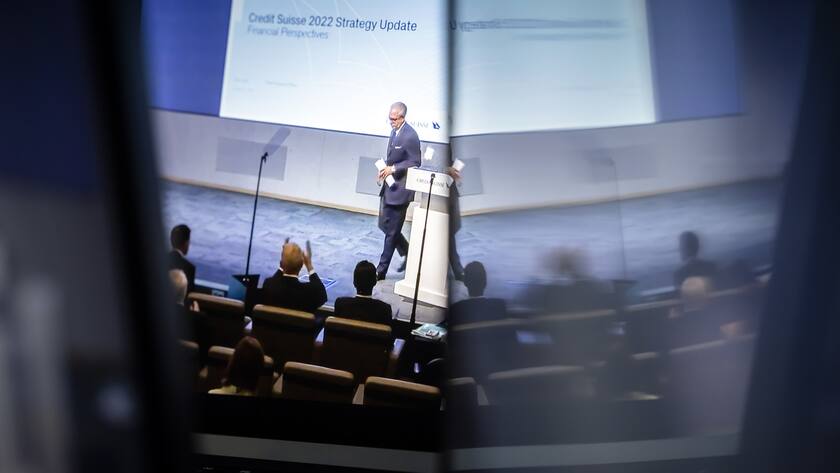Swiss bank Credit Suisse CEO Ulrich Koerner, center, is seen on screens presenting the quarterly report and the strategy and transformation plan for the bank taken from a webcast streaming in Zurich, Switzerland on Thursday, October 27, 2022. (KEYSTONE/Michael Buholzer