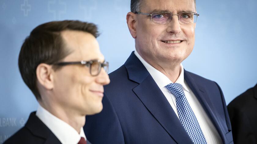 Swiss National Bank's (SNB) Chairman of the Governing Board Thomas Jordan, right, arrives with Vice Chairman of the Governing Board Martin Schlegel, left, to a media briefing at the Swiss National Bank in Zurich, Switzerland, on Thursday, June 20, 2024. (KEYSTONE/Michael Buholzer)
