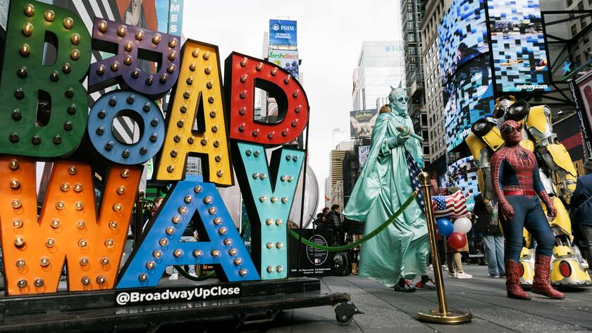 epa10309080 People dressed in costumes to pose with tourists for money walk through Times Square in New York, New York, USA, 16 November 2022. A recent estimate by NYC & Company, a not-for-profit organization that promotes New York tourism and travel, is estimating 6.5 million people will visit the city between Thanksgiving and New Years and that the city will have nearly 85% of its record number tourist visitors in 2019. EPA/JUSTIN LANE