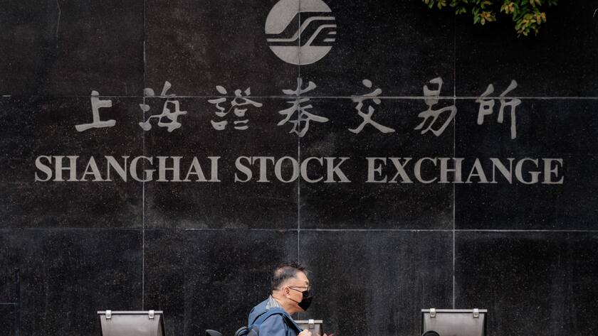 epa10556982 A man walks in front of the Shanghai Stock Exchange Building, in Shanghai, China, 03 April 2023. Micron Technology stock dropped on 03 April after the Cyberspace Administration of China reported a cybersecurity review of products sold by Micron in the country. EPA/ALEX PLAVEVSKI