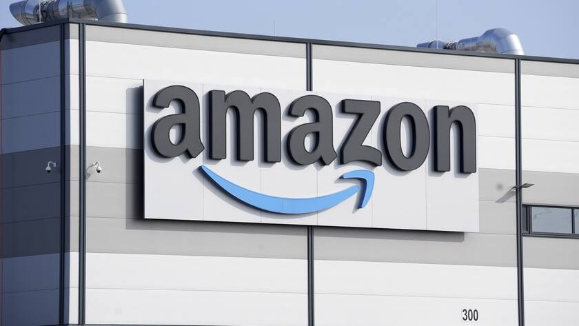 FILE - An Amazon company logo marks the facade of a building in Schoenefeld near Berlin, March 18, 2022. Amazon said on Tuesday, Sept. 19, 2023, that it will hire 250,000 full- and part-time workers for the holiday season, a 67% jump compared to last year. (AP Photo/Michael Sohn, File)