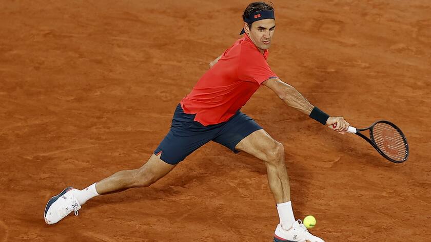 epa09250136 Roger Federer of Switzerland in action against Dominik Koepfer of Germany during their third round match at the French Open tennis tournament at Roland Garros in Paris, France, 05 June 2021. EPA/IAN LANGSDON